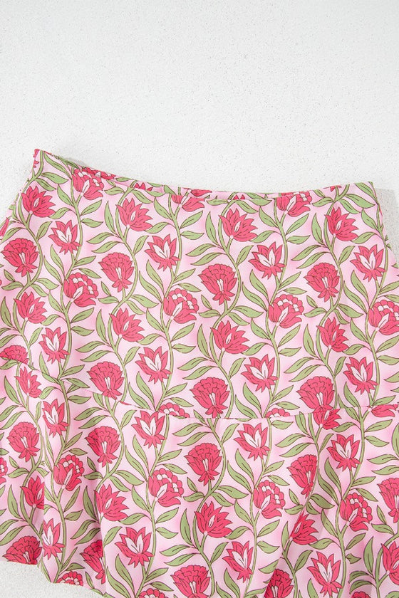 Close-up shots of the mini skirt showcasing the floral print detailing and soft flowing fabric, emphasizing the texture and lightness that make it ideal for summer wear.

