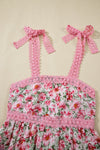 Closeup of the neckline and strap area of the pink floral dress, highlighting the square cut, neat seams, and breezy design perfect for warmer days.

