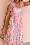  Front detail view of the pink floral dress with square neckline and visible pocket seams, combining utility with a stylish summer-ready design.

