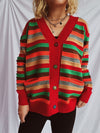 Close-up of a Contrast Stripes Button-Up Long Sleeve Cardigan with vibrant horizontal stripes in red, green, and beige tones, styled casually with black pants.