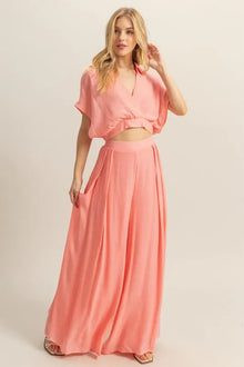  Stylish front view of the coral top and matching wide leg pants set, featuring a relaxed silhouette, perfect for warm weather days and casual chic styling.