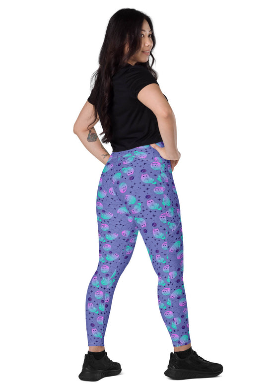 Full back view of woman wearing Cosmic Cat Slate Blue high-waisted leggings with pockets, offering a slim and flattering fit perfect for yoga or gym sessions.