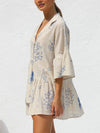 Side view of the Cream Button Detail Printed Mini Dress, emphasizing the sleek cut and soft flow of the fabric.