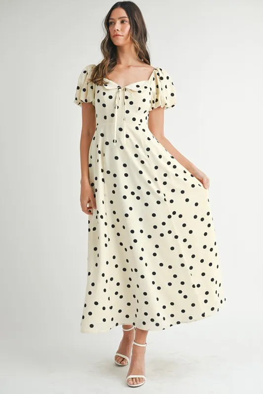 Cream puff sleeve midi dress with polka dots shown in full front view, highlighting its flowy silhouette and romantic charm.