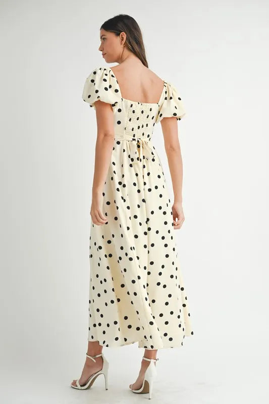 Full back view of cream midi dress with puff sleeves and soft dot print, offering a graceful and comfortable finish.