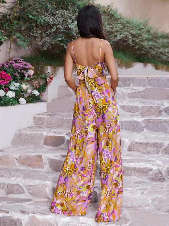 Back view of the Cutout Printed Spaghetti Strap Jumpsuit, highlighting the vibrant print and relaxed fit.