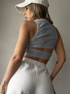 Back view of the Cutout Round Neck Tank in white, featuring a bold cutout detail and a comfortable, stylish design.