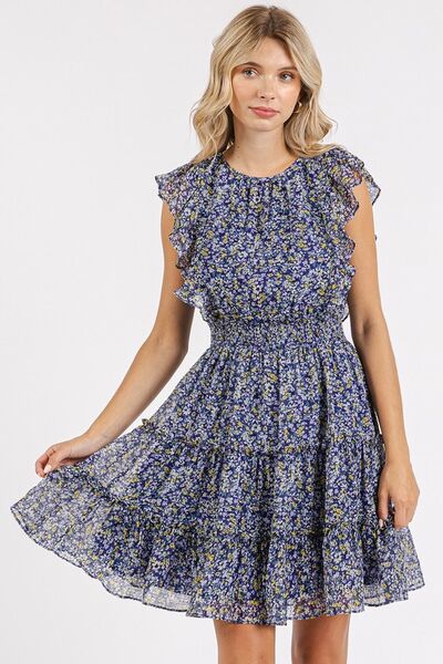 A front view of the Dark Navy Whisper Floral Ruffle Mini Dress, highlighting the soft floral pattern, ruffled hem, and flattering fit for a romantic and elegant vibe.