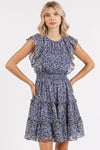 A close-up of the Dark Navy Whisper Floral Ruffle Mini Dress, focusing on the delicate floral print and the feminine ruffled details for a soft, dreamy look.