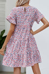 Back view of the Ditsy Floral Tiered Dress, highlighting the relaxed fit and flounce sleeves.