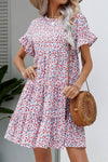 Front view of the Ditsy Floral Flounce Sleeve Tiered Dress with a round neckline and floral pattern.