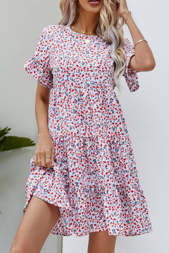 Woman wearing a ditsy floral mini dress with flounce sleeves and a tiered design, perfect for casual outings and vacations.