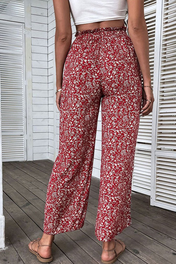 Back view of ditsy floral slit paperbag waist pants showing wide-leg fit and slit detail.