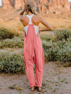  Back view of the Double Take Jumpsuit emphasizing the relaxed fit and pocket detail.