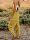  Side view of the jumpsuit highlighting the V-neck and flowy silhouette.