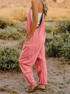 Side view of the jumpsuit highlighting the V-neck and flowy silhouette.