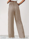 Back view of Drawstring Striped Elastic Waist Pants, featuring vertical stripes and a relaxed wide-leg design.