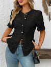 Woman showcasing front fit of black lace shirt featuring floral lace and chic tailoring for a polished outfit.