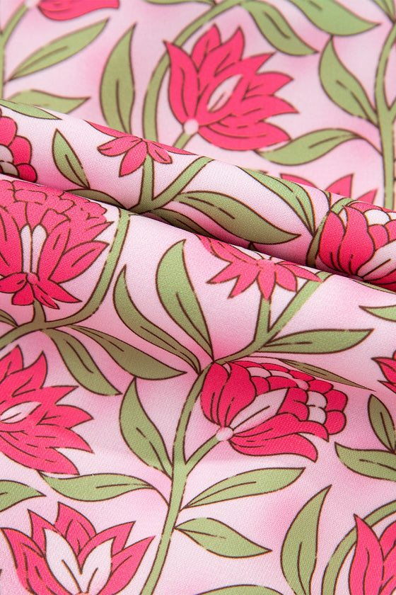 Close-up shots of the fabric of dress showcasing the floral print detailing and soft flowing fabric, emphasizing the texture and lightness that make it ideal for summer wear.