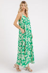  A flirty, stylish kelly green printed v-neck cami maxi dress featuring convenient pockets for added practicality while keeping you fashionable.