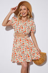 Front view of the Floral Cutout Short Puff Sleeve Dress with a floral print and waist cutout.