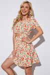 Model wearing the Floral Cutout Short Puff Sleeve Dress, styled with a summer hat for a chic look.