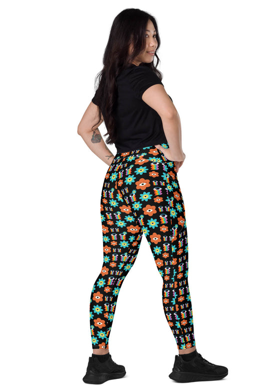 Back view of woman standing in Floral Print Black Yoga Leggings with Pockets. Elegant floral print and high-waisted design, great for yoga or casual outings.