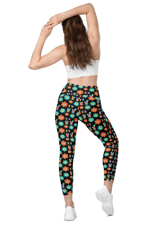 Back view of woman in Floral Print Black Yoga Leggings with Pockets. High-waisted and flattering fit with feminine floral details, ideal for yoga and workouts.