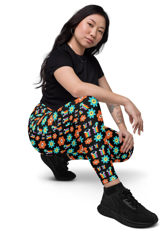 Woman sitting in Floral Print Black Yoga Leggings with Pockets. Soft and comfortable leggings with a flattering high-rise fit and stylish floral accents.