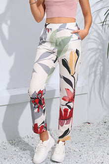  Woman wearing floral print cropped pants with pockets, perfect for a chic, casual style with vibrant patterns.