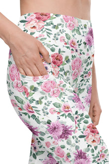  Close-up of Floral Print White high-waisted leggings with side pockets. Featuring vibrant roses and peonies on a crisp white background, perfect for yoga, gym, or casual wear.
