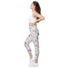 Full side view of woman wearing Floral Print White high-waisted leggings with side pockets. Flattering floral design, ideal for any active or casual occasion.