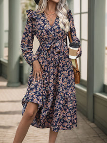  Woman wearing a Floral Printed Surplice Long Sleeve Midi Dress, styled with a coffee cup and accessorized for a chic autumn look.