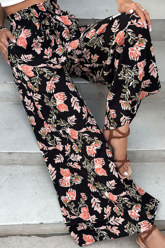 Close-up of the floral fabric on Floral Pull-On Wide Leg Pants, showing vibrant pink and green floral design against a dark base.