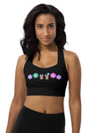 Woman wearing the Floral Rainbow Print Black High Impact Sports Bra. Bold purple, pink, and blue floral design against black, offering high support for intense workouts. Stylish and functional for all activities.