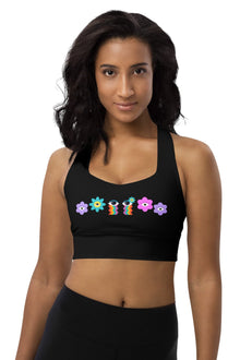  Woman wearing the Floral Rainbow Print Black High Impact Sports Bra. Bold purple, pink, and blue floral design against black, offering high support for intense workouts. Stylish and functional for all activities.