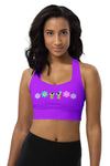 Woman wearing the Floral Rainbow Print Purple Racerback Longline Sports Bra. Featuring a vibrant mix of purple, pink, and blue hues, offering high support and maximum comfort for both workouts and casual wear.
