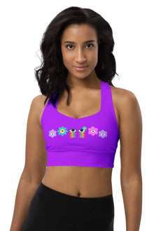  Woman wearing the Floral Rainbow Print Purple Racerback Longline Sports Bra. Featuring a vibrant mix of purple, pink, and blue hues, offering high support and maximum comfort for both workouts and casual wear.
