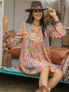 Side multicolor view of the Floral Ruched V-Neck Long Sleeve Dress, highlighting the ruched detail and long sleeves. 