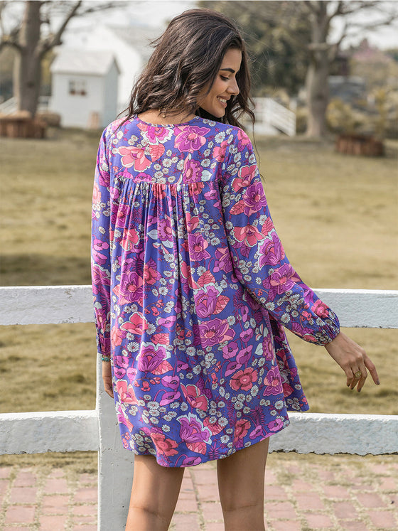 Back view of the Floral Ruched purple V-Neck Long Sleeve Dress, highlighting the ruched detail and long sleeves.