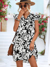 Woman wearing the Floral Tie Neck Butterfly Sleeve Dress styled with a straw hat and sunglasses for a chic summer look.