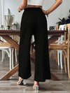 Back view of Frill Wide Leg Pants in beige with a wide-leg silhouette and functional side pockets.