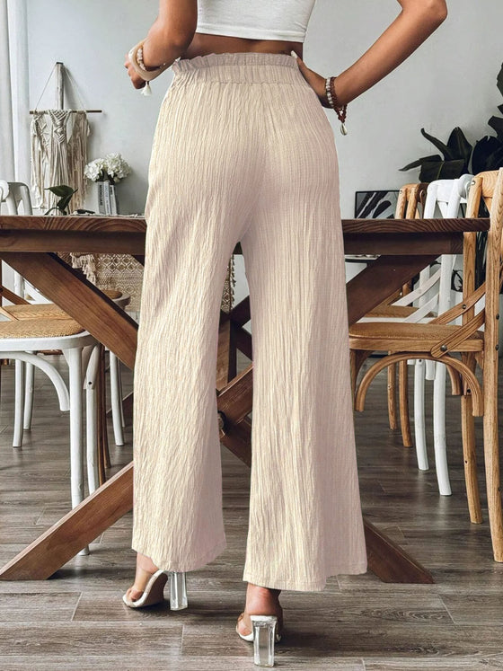 Back view of Frill Wide Leg Pants in beige with a wide-leg silhouette and functional side pockets.