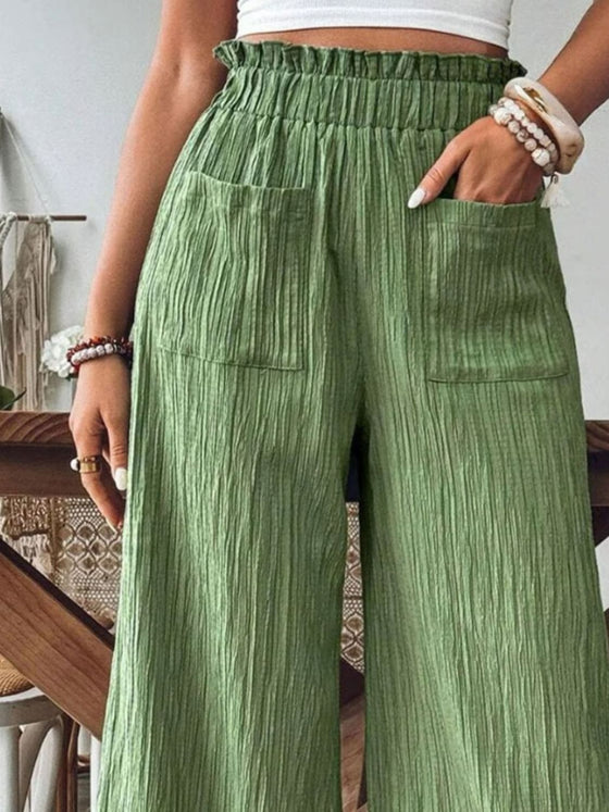 Woman styling the Frill Wide Leg Pants with a crop top, perfect for casual and relaxed summer days.