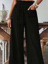 Woman styling the Frill Wide Leg Pants with a crop top, perfect for casual and relaxed summer days.