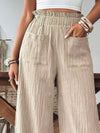 Woman styling the Frill Wide Leg Pants with a crop top, perfect for casual and relaxed summer days.