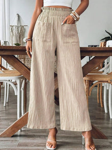  Woman wearing Frill Wide Leg Pants with a cropped top, showcasing the wide-leg design and functional pockets, ideal for casual or summer wear.

