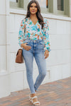 Model shows off the elegant fit of the bodysuit, with exaggerated sleeves adding drama to the otherwise fitted, feminine silhouette.

