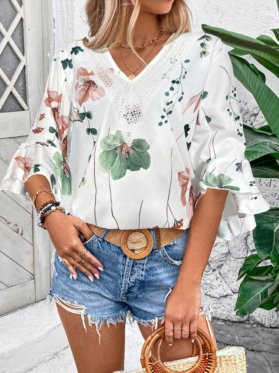 Model showcasing a modern printed white blouse with comfortable half sleeves and a flattering neckline from the front view.