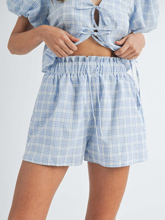 Styled front view showing off the V-neck puff sleeve top paired with matching shorts, ideal for sunny days or beach vacations, offering both comfort and style.

